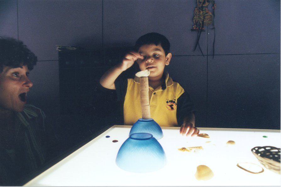 child building on light boxes